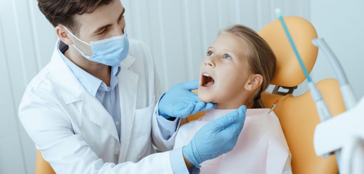 A dentist treating a kid's teeth