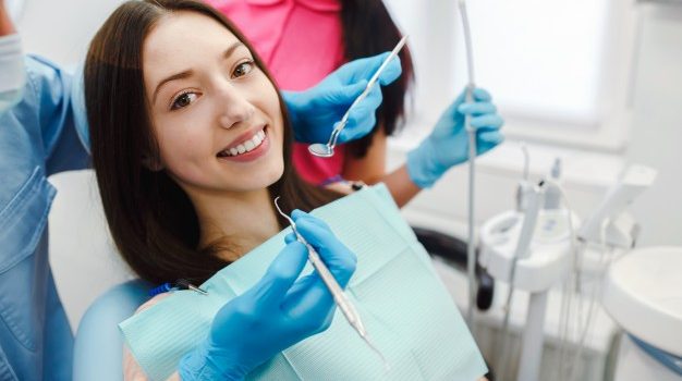 smiling woman dentist chair