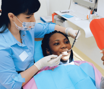 The dentist places a filling for the patient's front teeth