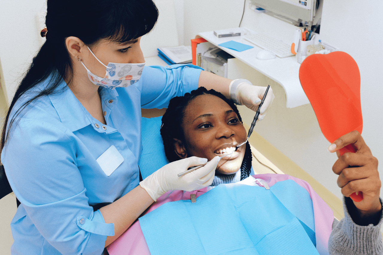 The dentist places a filling for the patient's front teeth